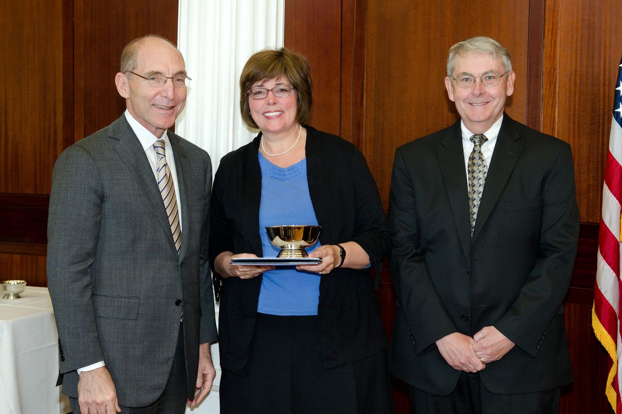 UK President Eli Capilouto, left, and G.T. Lineberry, associate provost for faculty advancement, present the Sturgill Award to Linda Kraus Worley, professor of modern and classical languages, literatures, and cultures in the UK College of Arts and Sciences. 