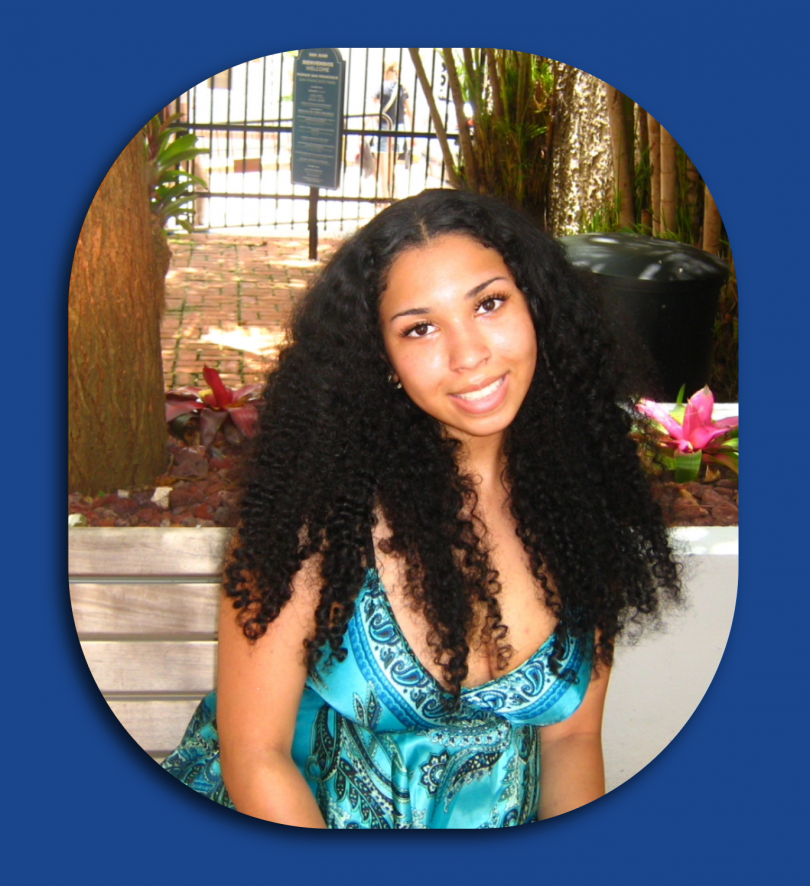 Woman sits on bench.